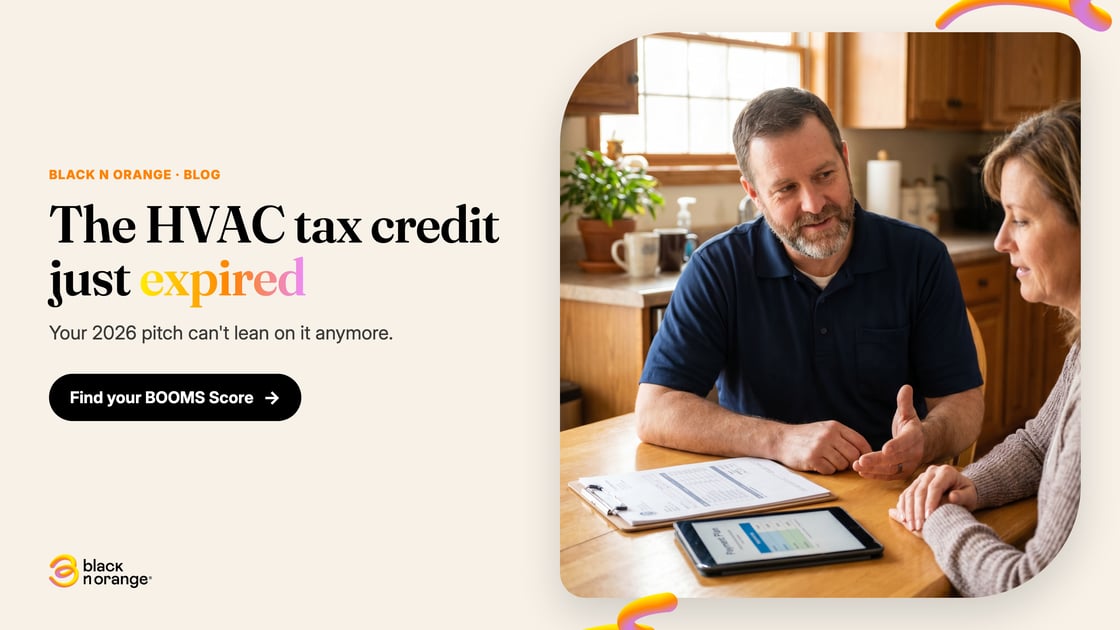 HVAC company owner explaining financing and quote options to a homeowner at the kitchen table, without leaning on the expired federal tax credit